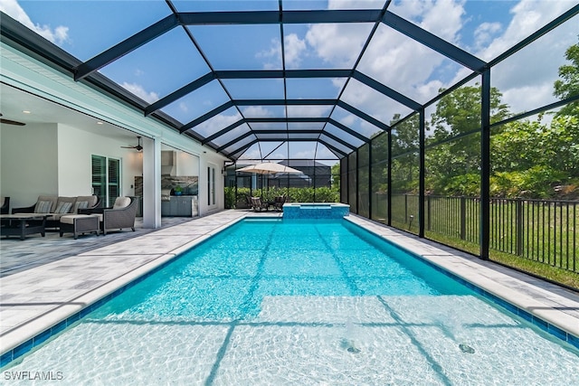 view of swimming pool featuring glass enclosure, ceiling fan, a patio, and an outdoor hangout area