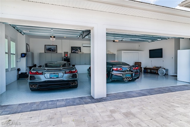 garage featuring a garage door opener, a carport, and white fridge