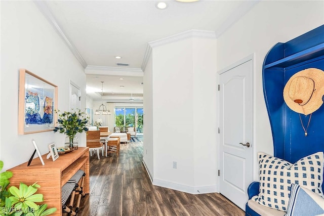 foyer entrance with ornamental molding and dark hardwood / wood-style flooring