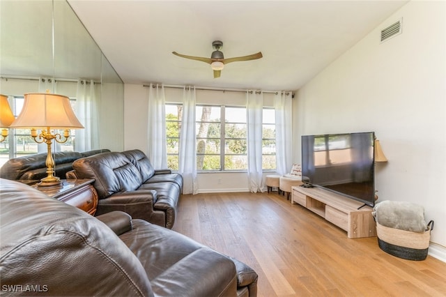 living room with light wood-type flooring, lofted ceiling, and ceiling fan