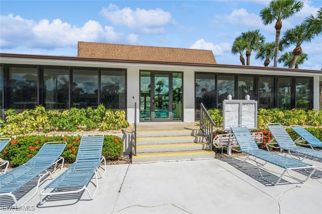 back of house featuring a sunroom and a patio area