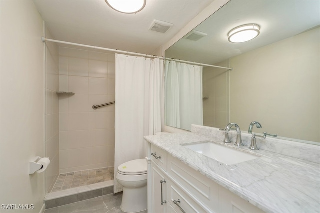 bathroom featuring a shower with shower curtain, vanity, and toilet