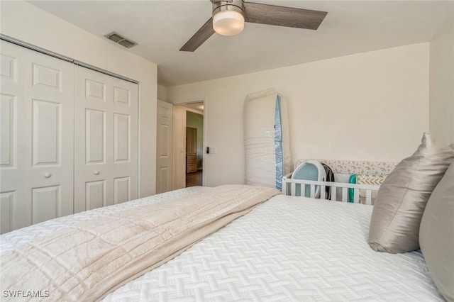 bedroom with ceiling fan and a closet