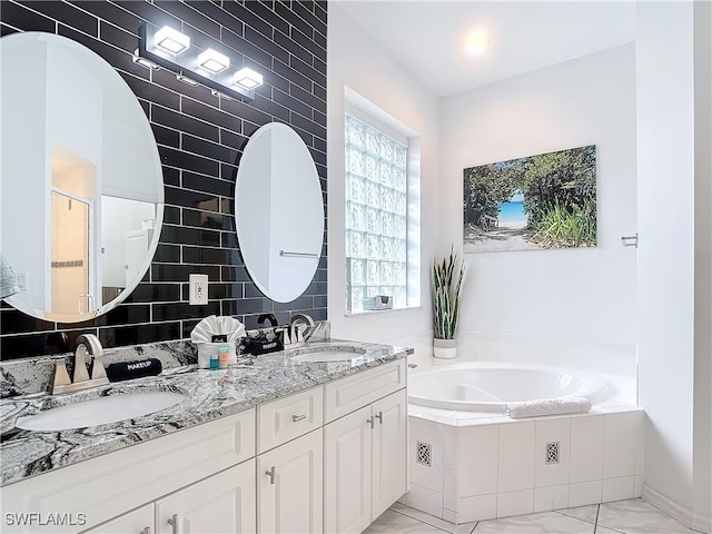 bathroom with tile walls, vanity, and plus walk in shower