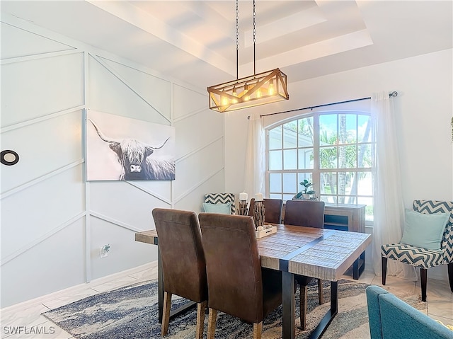 dining area with a raised ceiling