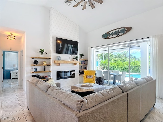 living room featuring a large fireplace, ceiling fan, and high vaulted ceiling