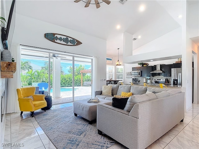 living room featuring ceiling fan and high vaulted ceiling