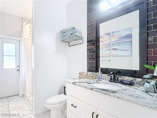 bathroom featuring vanity, toilet, and a shower with shower curtain