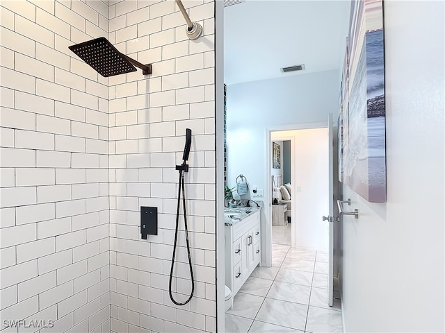 bathroom with vanity and tiled shower