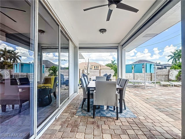 sunroom featuring ceiling fan