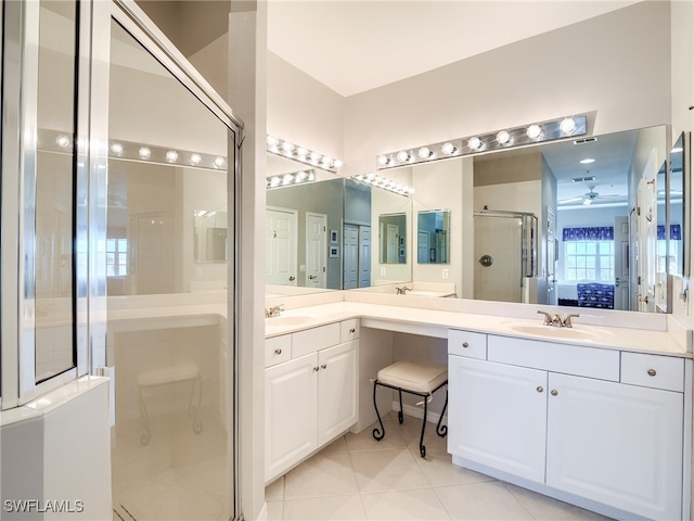 bathroom featuring vanity, tile patterned flooring, and a shower with shower door