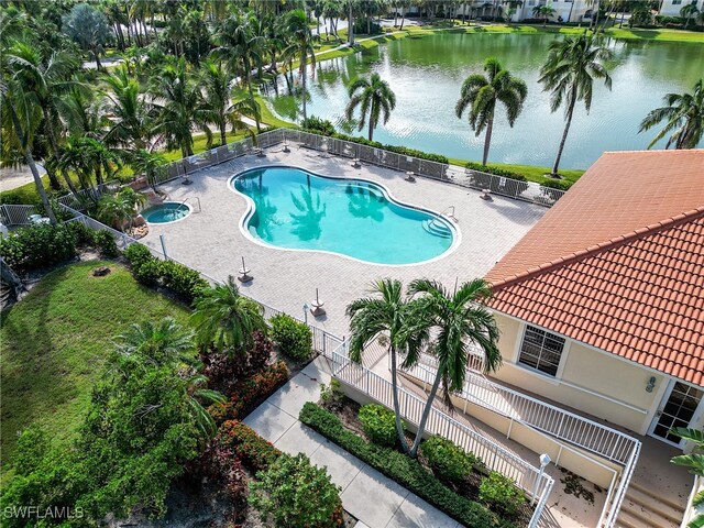 view of pool featuring a patio and a water view