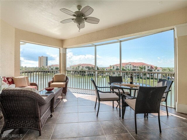 20011 Sanibel View Cir # 302, Fort Myers, FL 33908 - sunroom / solarium with a ceiling fan, a water view, and tile patterned floors