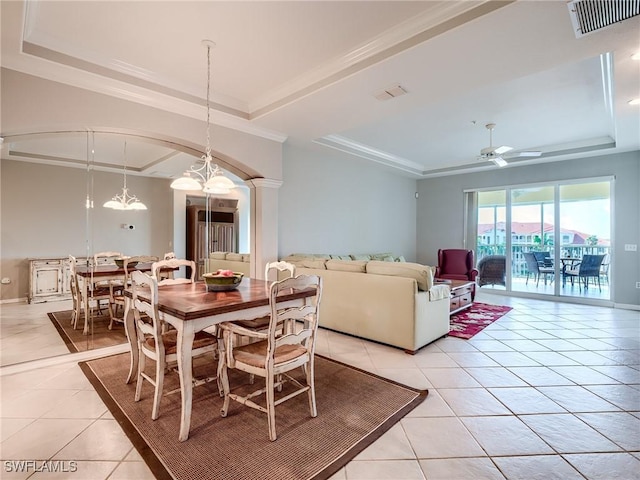 20011 Sanibel View Cir # 302, Fort Myers, FL 33908 - dining room featuring a tray ceiling, light tile patterned floors, ceiling fan, ornamental molding, and arched walkways
