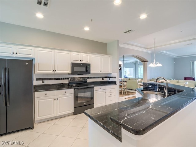 20011 Sanibel View Cir # 302, Fort Myers, FL 33908 - kitchen with black appliances, arched walkways, white cabinetry, crown molding, and pendant lighting