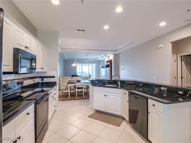 20011 Sanibel View Cir # 302, Fort Myers, FL 33908 - kitchen with black appliances, white cabinets, recessed lighting, light tile patterned floors, and dark stone countertops