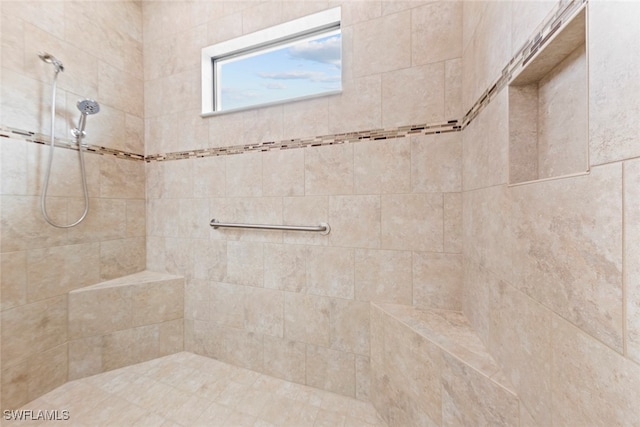 bathroom with tiled shower