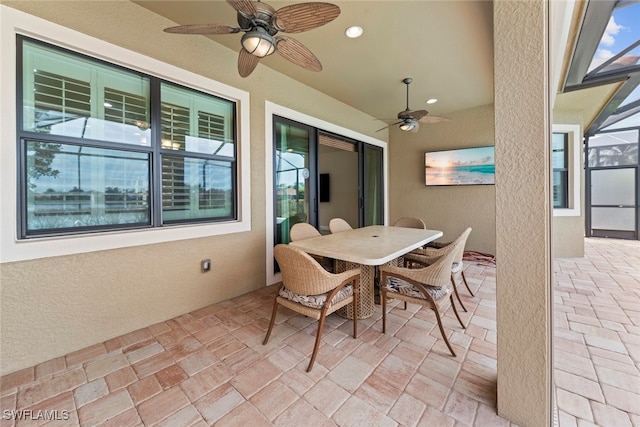 view of patio / terrace featuring a lanai and ceiling fan