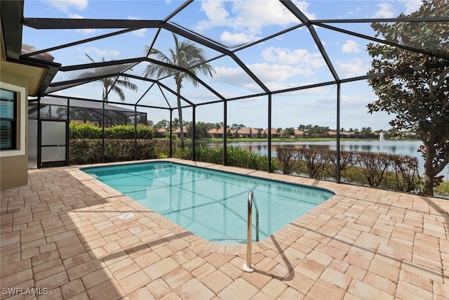 view of pool featuring a patio, a water view, and glass enclosure