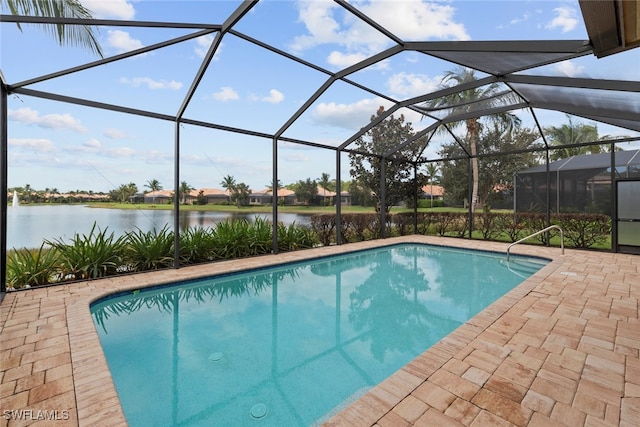 view of pool featuring a water view, a patio, and glass enclosure