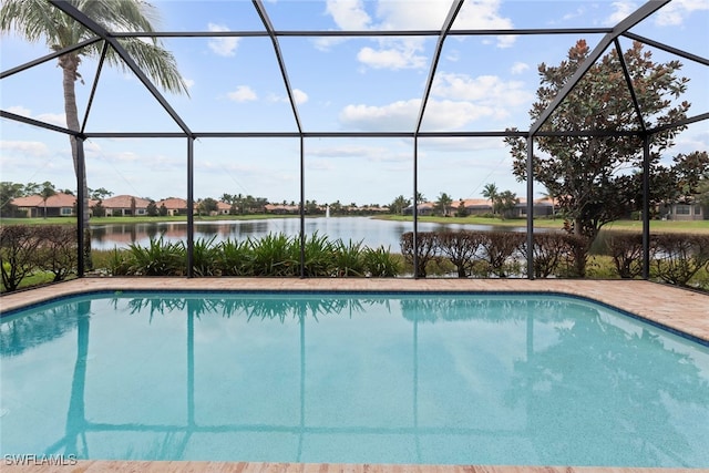 view of pool with a lanai and a water view