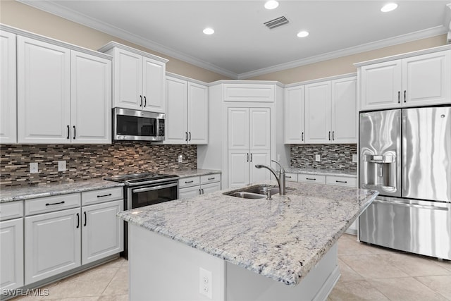 kitchen featuring stainless steel appliances, sink, a center island with sink, and white cabinets