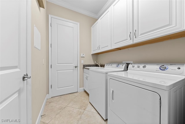 clothes washing area featuring cabinets, light tile patterned floors, washing machine and clothes dryer, crown molding, and sink