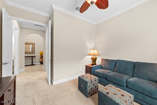 carpeted living room with ceiling fan and ornamental molding