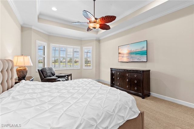 bedroom featuring light carpet, crown molding, a raised ceiling, and ceiling fan