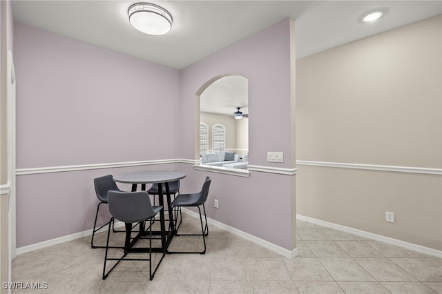 dining space featuring ceiling fan and light tile patterned flooring