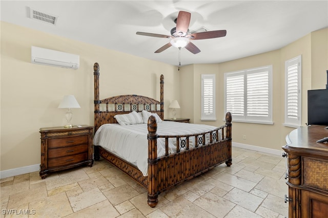 bedroom featuring ceiling fan and an AC wall unit