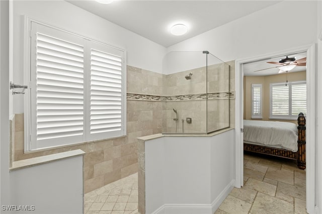 bathroom featuring tiled shower and ceiling fan