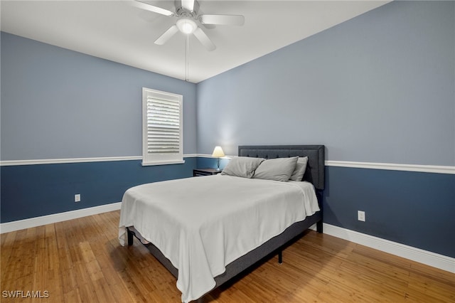 bedroom with wood-type flooring and ceiling fan