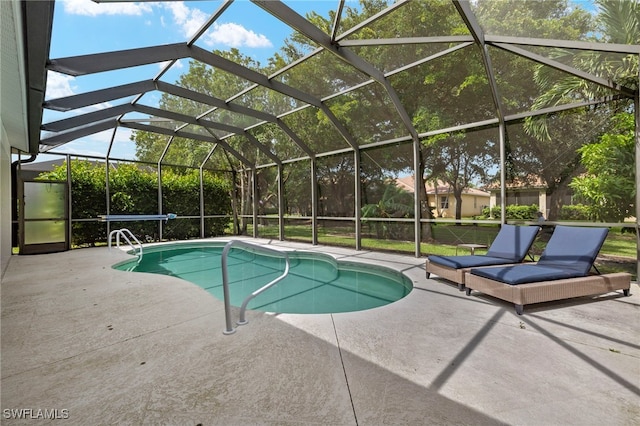 view of swimming pool with a patio area and glass enclosure