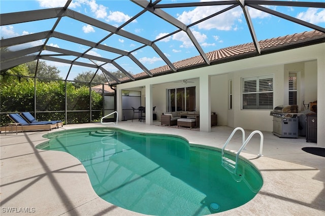 view of pool with a patio, an outdoor hangout area, ceiling fan, and glass enclosure