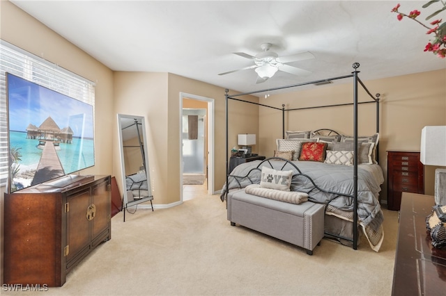 carpeted bedroom featuring ceiling fan and ensuite bathroom