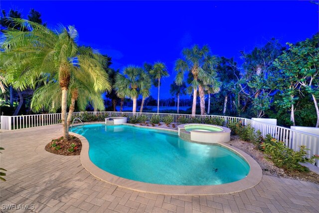 view of swimming pool with an in ground hot tub and a patio