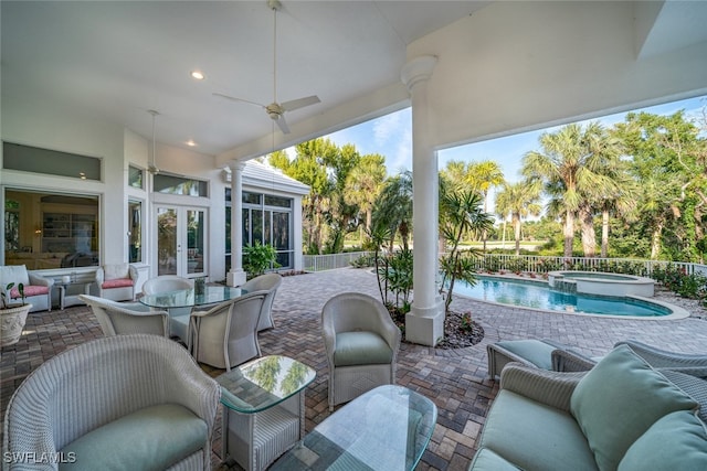 view of patio / terrace featuring ceiling fan and a pool with hot tub