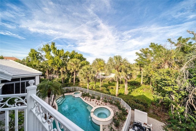 view of swimming pool featuring an in ground hot tub