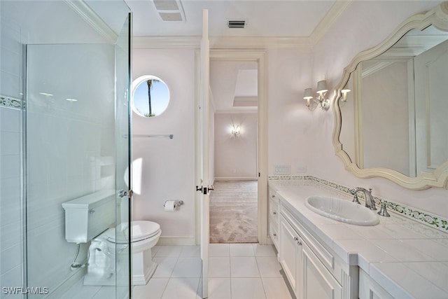 bathroom featuring vanity, crown molding, toilet, and tile patterned floors