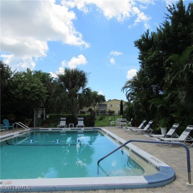 community pool with a patio area