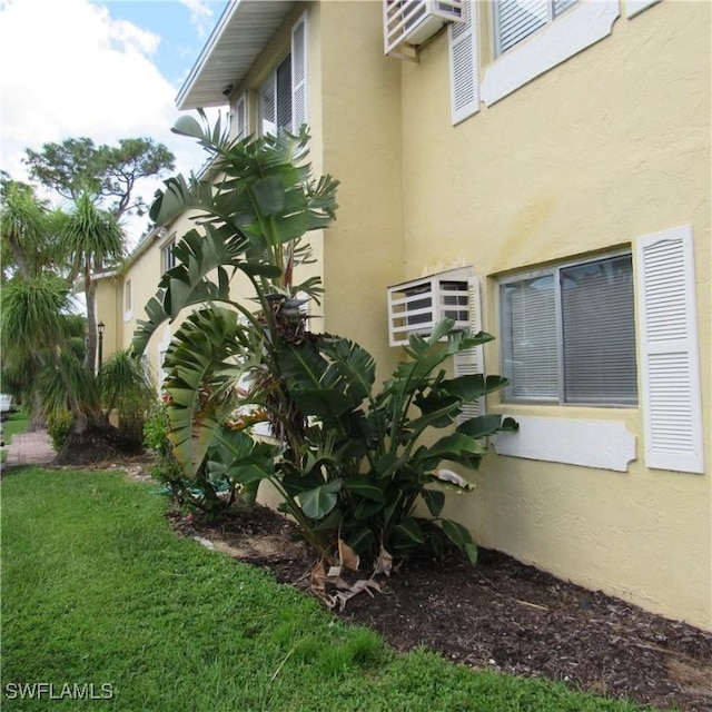 8156 Country Rd Unit 106, Fort Myers, FL 33919 - view of side of home featuring stucco siding and a lawn