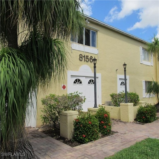 property entrance with stucco siding