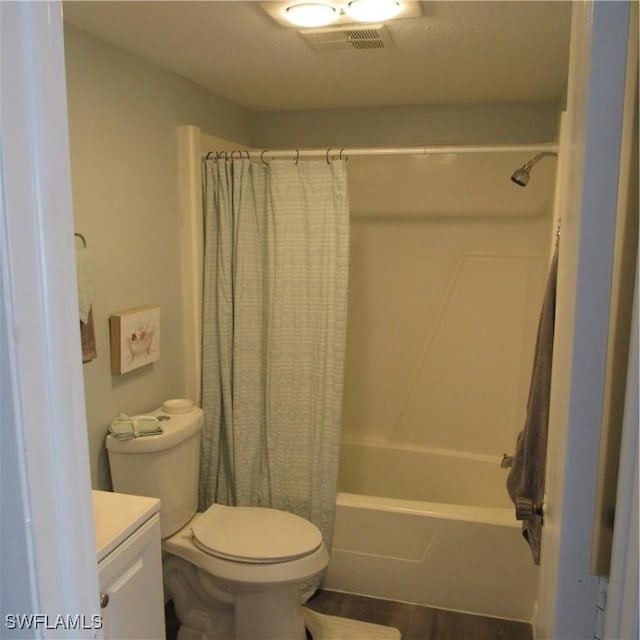 full bath featuring toilet, wood finished floors, vanity, visible vents, and shower / bath combination with curtain