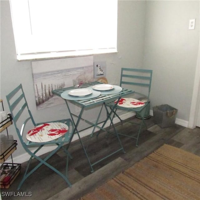 dining area with wood finished floors and baseboards