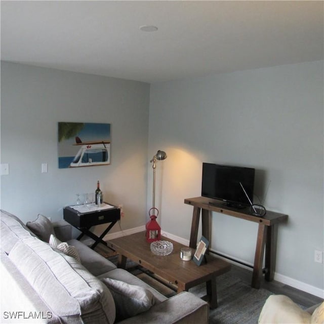 living room with wood finished floors and baseboards