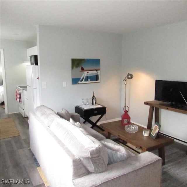 living room with baseboards and wood finished floors