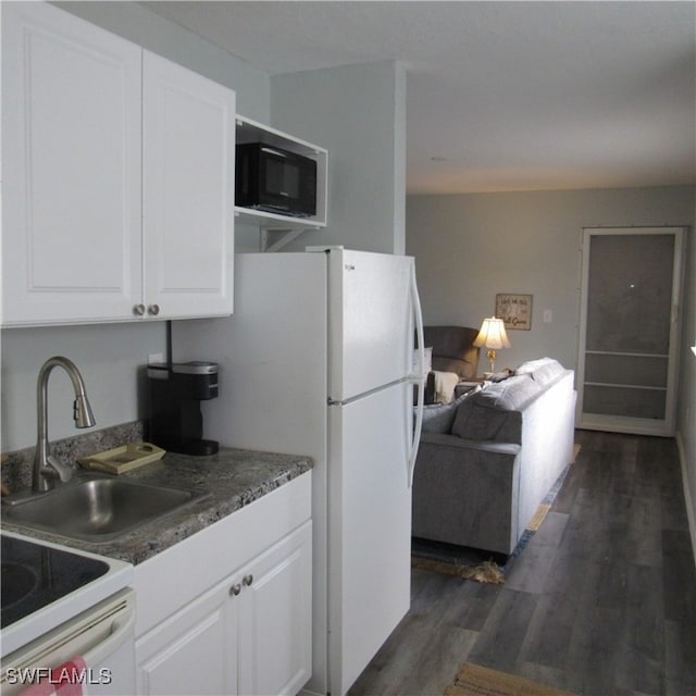 kitchen featuring white cabinets, sink, dark wood-type flooring, and white appliances