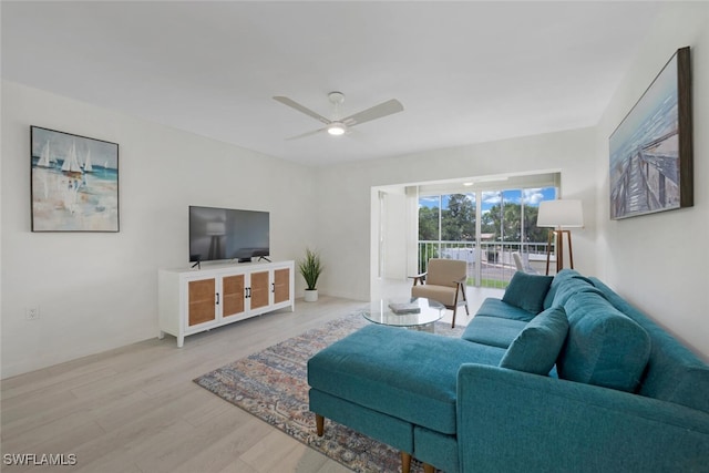 living room featuring ceiling fan and light hardwood / wood-style flooring