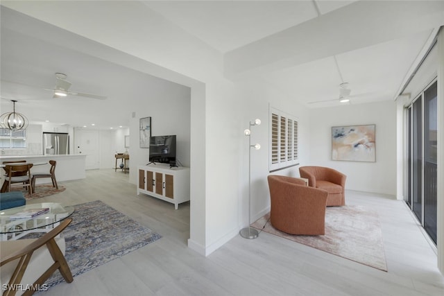 living room featuring an inviting chandelier and light wood-type flooring